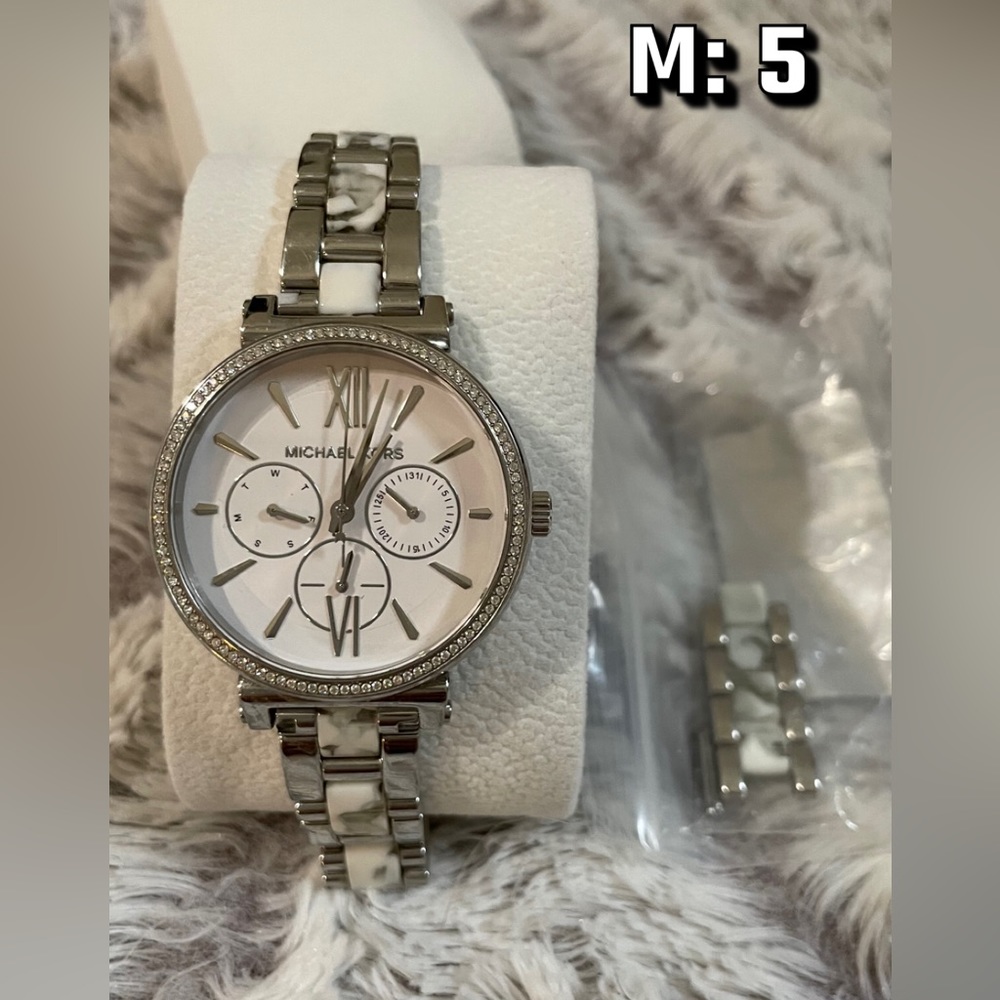 Michale Kors Silver watch with White and Black Marble accents.